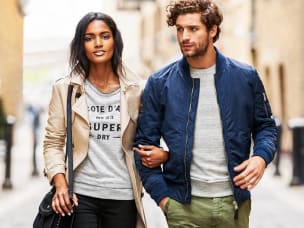 Man and Woman walking down street in Superdry clothing
