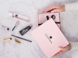Someone unboxing a Glossybox to announce that Awin's affiliate program for Glossybox is open