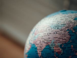 Photo of a globe zoomed in on China.