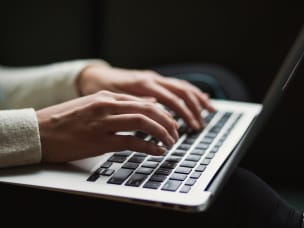 person typing on a laptop