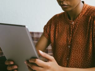 Women using tablet while shopping online at home
