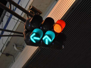 Green arrow and red traffic light in urban landscape