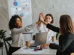 Text saying "Accelerate your affiliate program with these five features" with three women high fiving