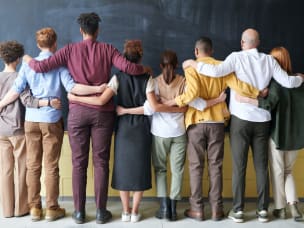 People standing next to each other, text saying "Four ways to champion a culture of diversity and inclusion"