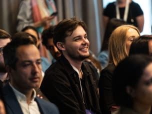 Guests attending London ThinkTank 2023, highlighting cheerful person in the centre