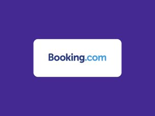 A smartphone displaying the Booking.com app, held by a hand with the brand logo visible