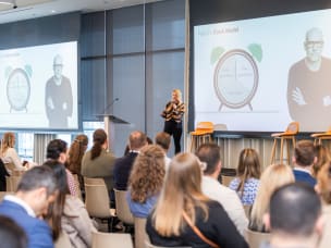 A speaker on stage with an audience watching at the Awin and ShareASale ThinkTank
