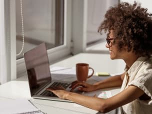 Person in an office setting, looking at Awin's five reasons on starting app tracking in 2023