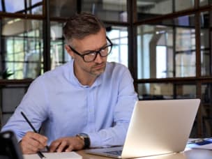 Man and woman working together on laptop screen
