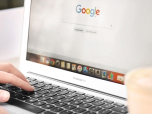 Person on their laptop on Google amid websites significantly losing rankings in Google’s search engine results pages (SERPs)