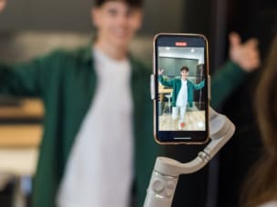 Influencer recording a video amid growing their reach by incorporating affiliate marketing