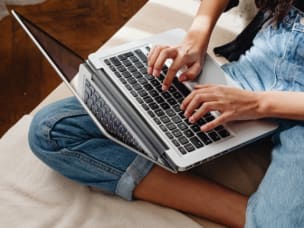 Person on laptop amid optimising performance in influencer collaborations with Awin's Commission by ClickRef
