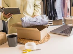 Person unpacking Black Friday purchases amid Awin recording biggest commission payday on record