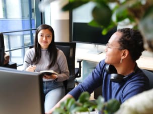 Two people in office, informing themselves about GDPR and ePrivacy guidelines provided by Awin