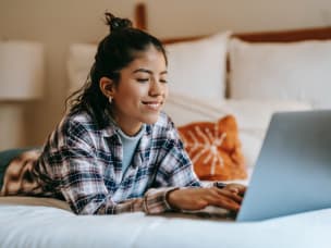 Person on their laptop, laying down, reading about Awin's approach to the GDPR