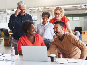 People in the office looking at Awin's top 10 affiliate marketers for 2024