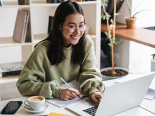 Person happy about simplified server-to-server tracking with Stape, looking at their laptop