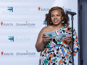A person on stage making an announcement at the ThinkTank Network Awards in Chicago.