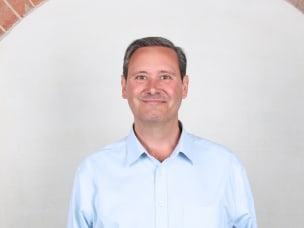 Gary Reck, standing in front of a wall, is the new Chief Product and Technology Officer at Awin