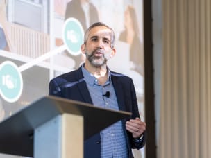 Adam Weiss, Awin Group President North America, answers all ShareASale questions, standing on stage