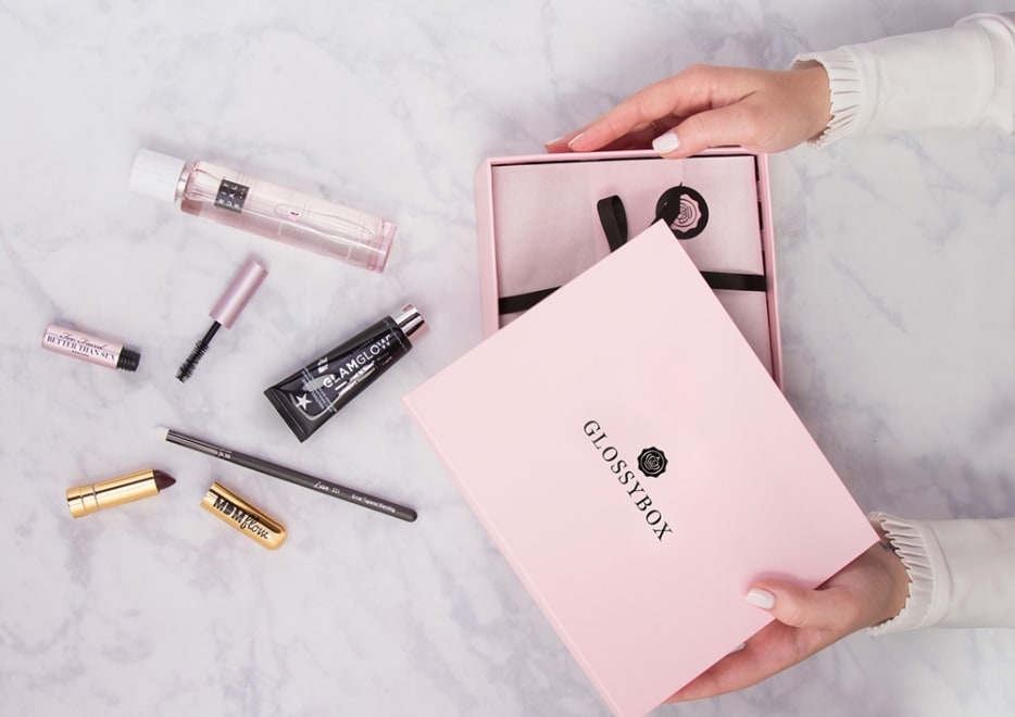 Someone unboxing a Glossybox to announce that Awin's affiliate program for Glossybox is open