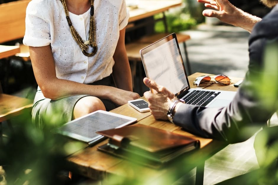 man and woman having meeting on laptop