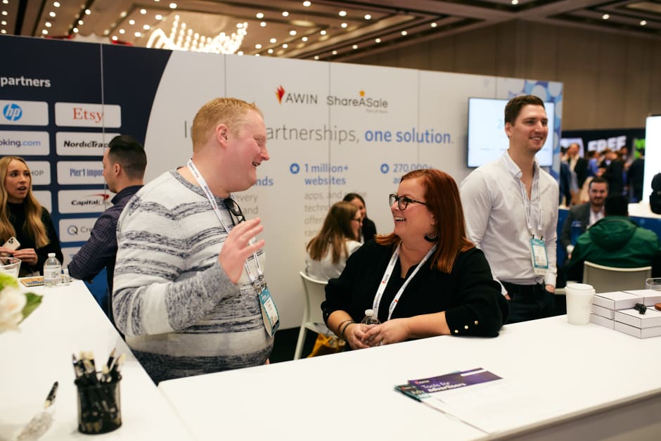 People attending and networking at Awin's stand at Affiliate Summit West 2023