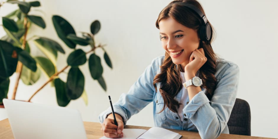 Person attending Awin's exclusive influencer marketing focused webinar, jotting down insightful information