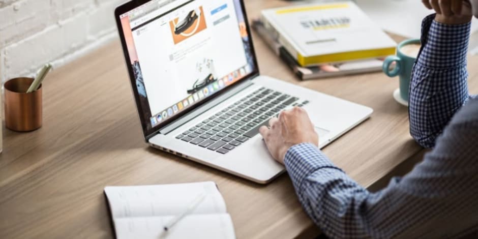 Person on laptop learning how to use link builder API to save time on bulk building Awin tracking links
