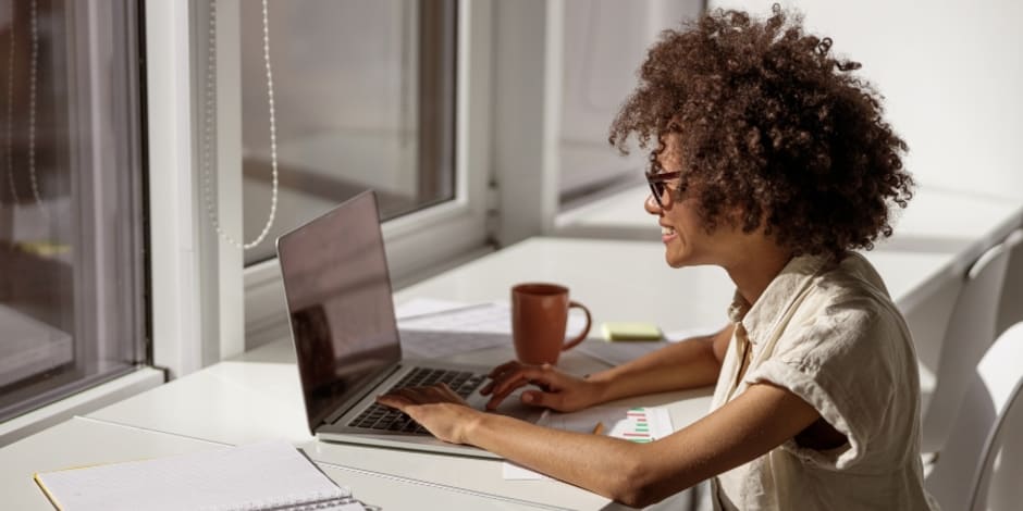 Person in an office setting, looking at Awin's five reasons on starting app tracking in 2023