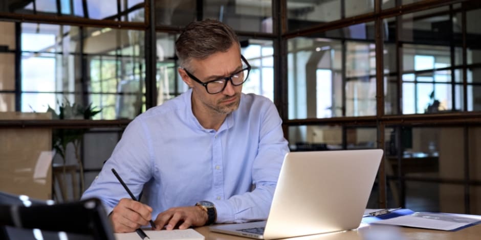 Man and woman working together on laptop screen