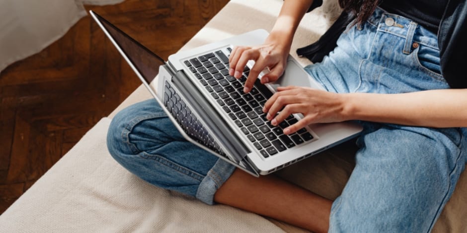 Person on laptop amid optimising performance in influencer collaborations with Awin's Commission by ClickRef
