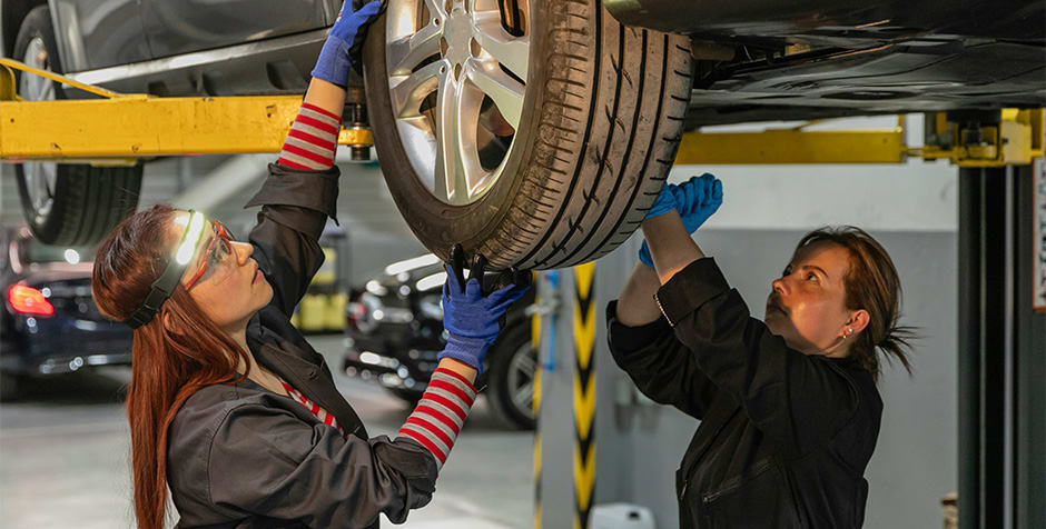 National Tyres employees working on tyres, while the company increased revenue with Awin’s one-click integration of UpSellit