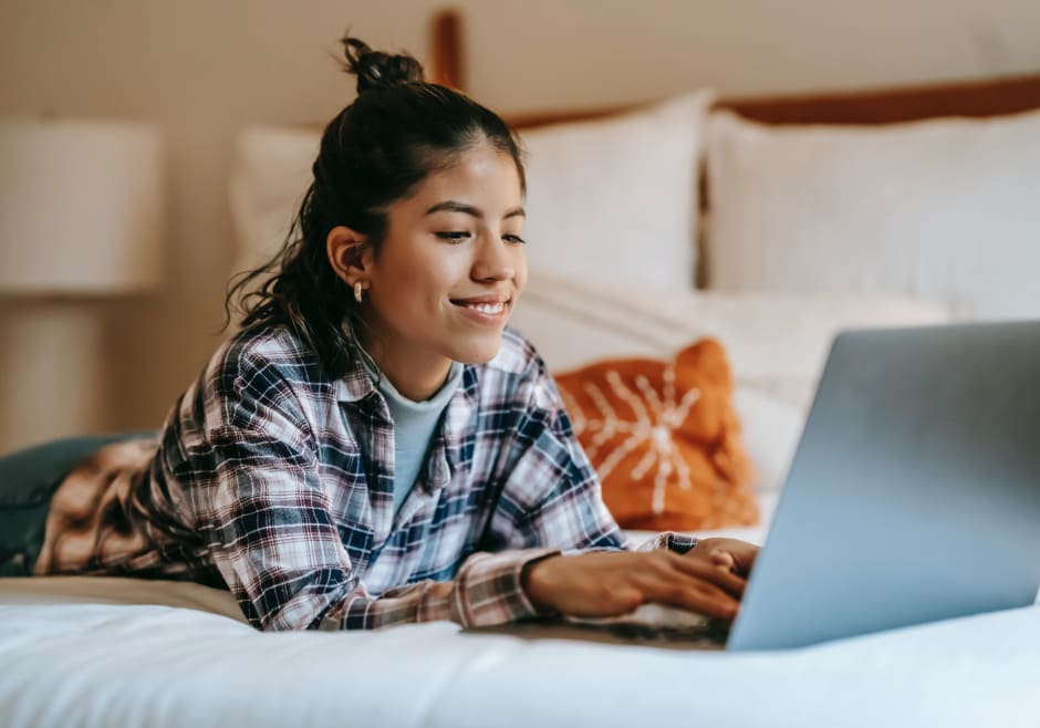 Person on their laptop, laying down, reading about Awin's approach to the GDPR