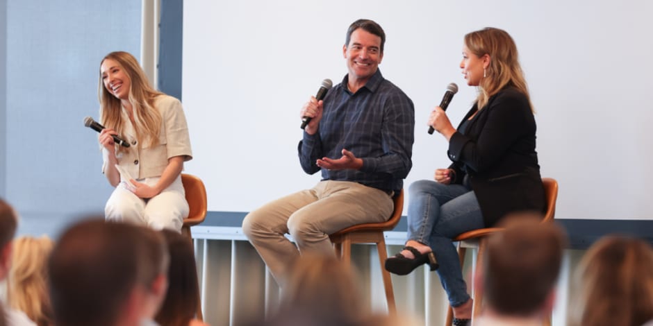 Three cheerful speakers, on stage, at ThinkTankUS