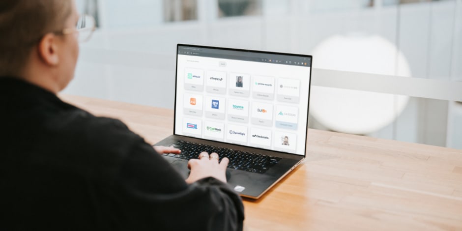 Employee on their computer looking at the 2024 Power 100, Awin's most innovative partners
