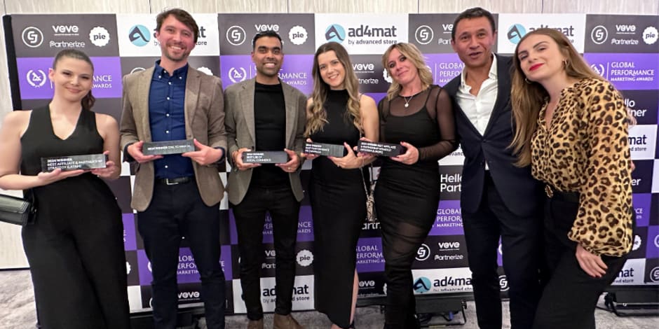 Seven people, including five Awin employees, holding the prizes at the Global Performance Marketing Awards.